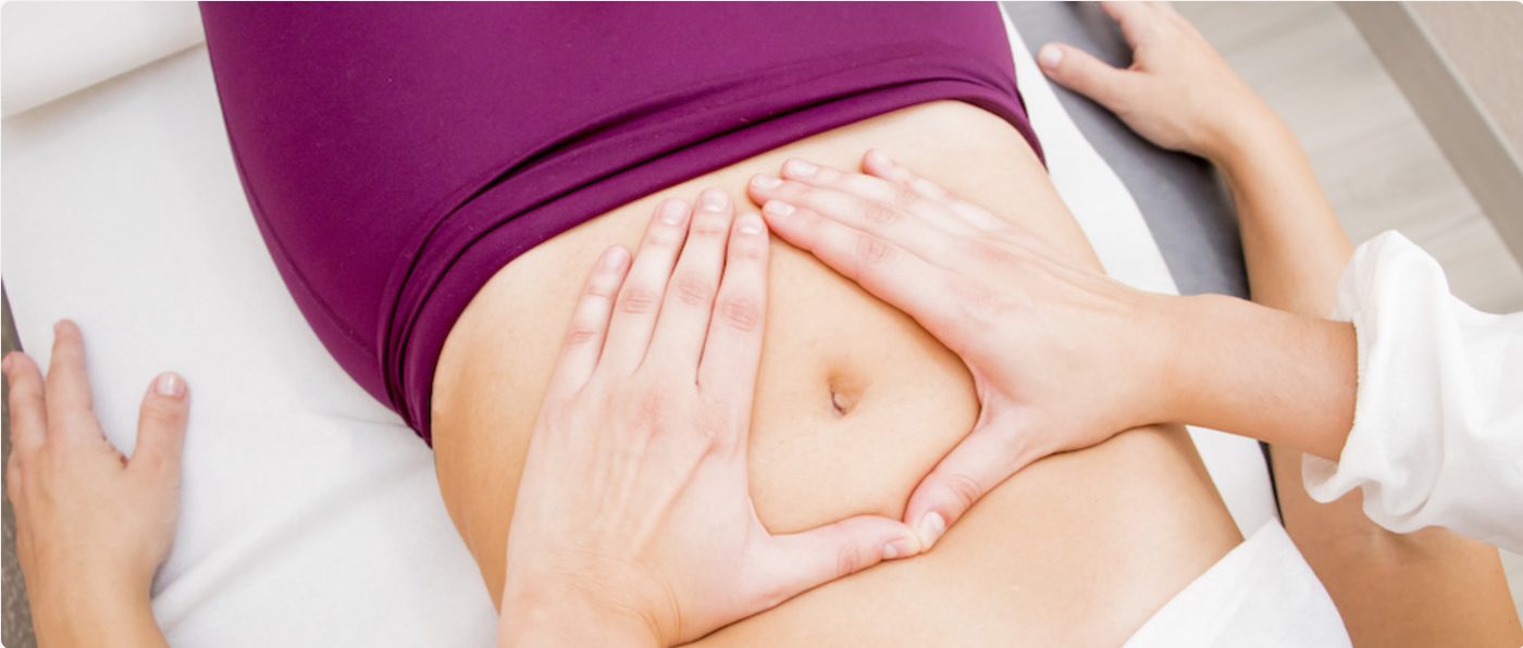 A therapist providing manual pelvic health treatment